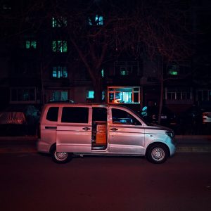 a van parked on the side of the road at night